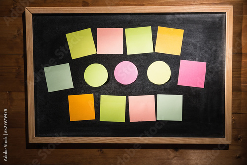 Colourful sticky notes on blackboard
