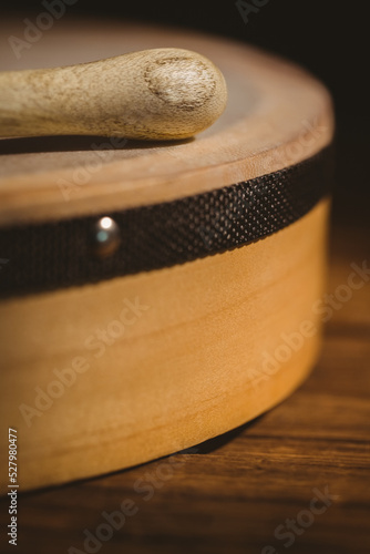 Close-up of wooden bodhran with stick