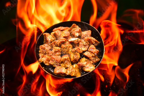 pork meat is cooked on fire