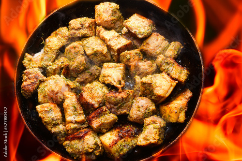 pork meat is cooked on fire