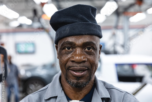 Portrait of a happy African American mechanic man photo