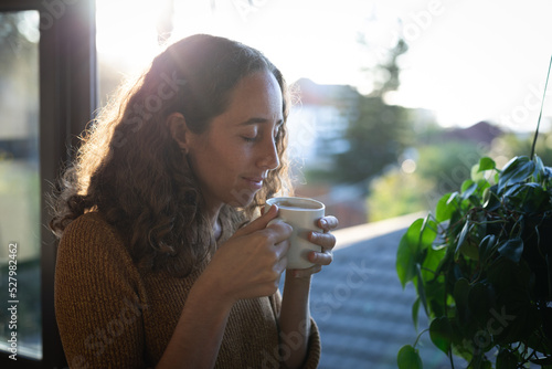 Woman having coffee. Social distancing in quarantine lockdown during coronavirus epidemic.