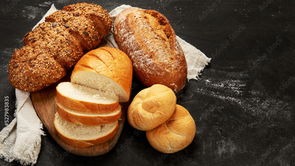 Bread assortment on dark background.