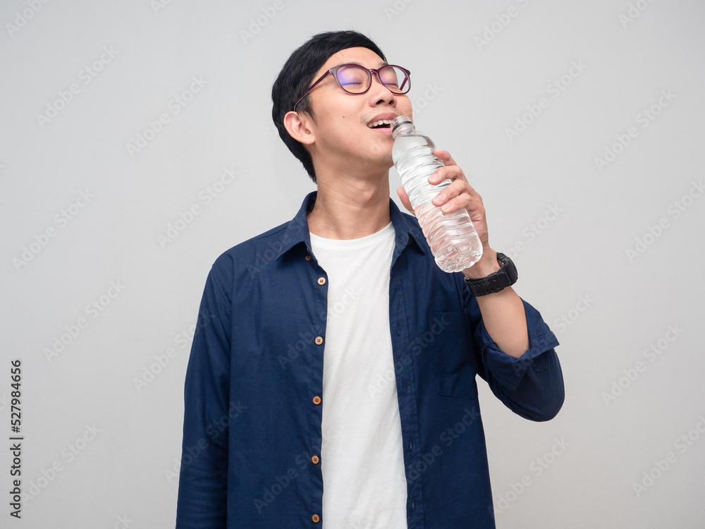 Young asian man wear glasses drinking water isolated Young asian man wear glasses drinking water isolated