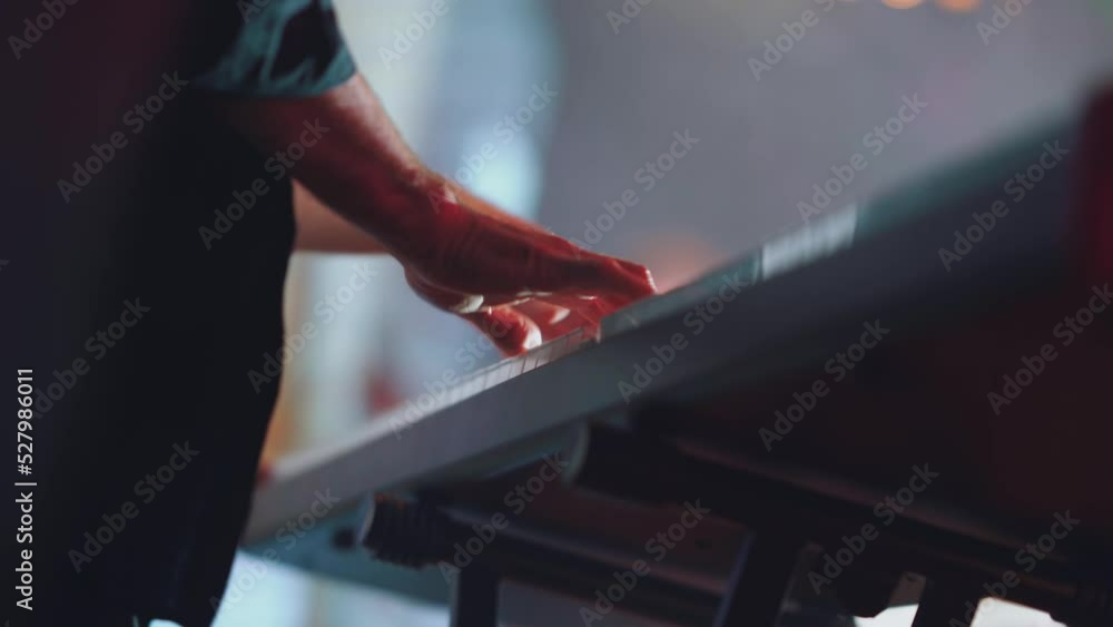 84. The keyboard player's hands play the synthesizer 84. The keyboard player's hands play the synthesizer