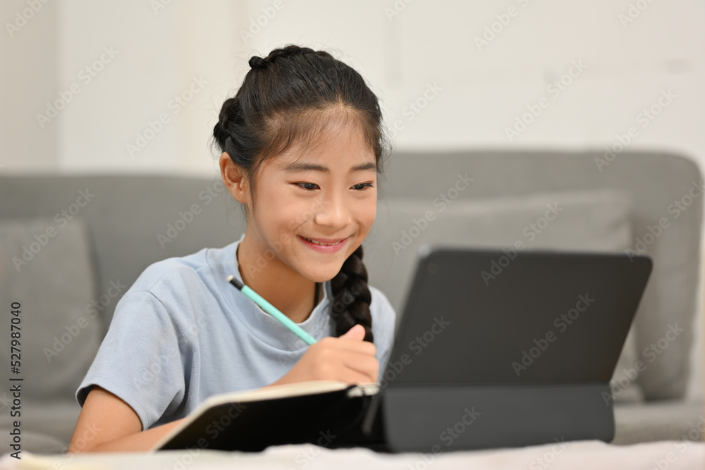 Little student girl using tablet for education and learning at home. Little student girl using tablet for education and learning at home.