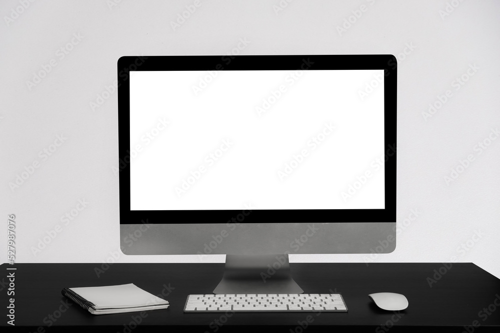 workspace with computers, keyboards, notebooks, and mice with a blank or white screen on a separate desk. workspace with computers, keyboards, notebooks, and mice with a blank or white screen on a separate desk.
