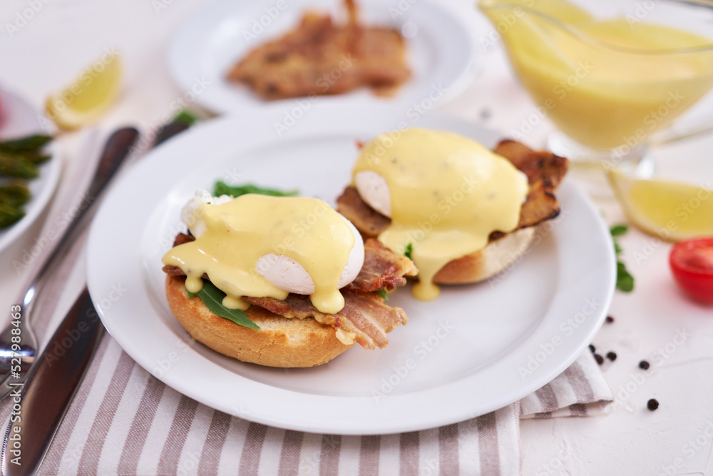 Tasty eggs Benedict, hollandaise sauce and bacon Tasty eggs Benedict, hollandaise sauce and bacon