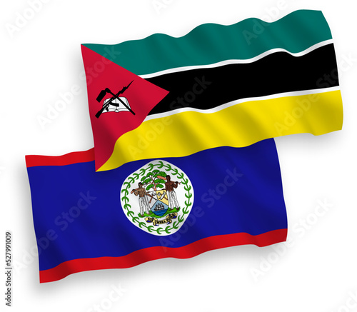 National vector fabric wave flags of Republic of Mozambique and Belize isolated on white background. 1 to 2 proportion.