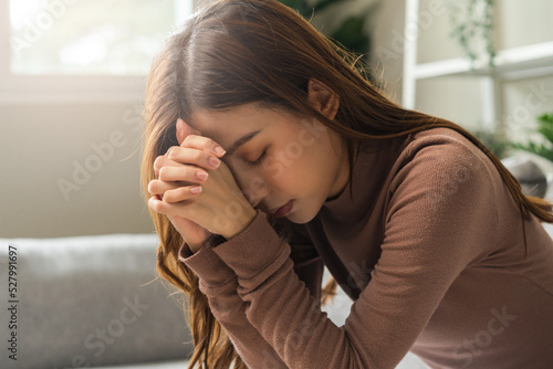 Fotografia Believe faith charity, calm asian young woman show gratitude, folded hands in prayer feel grateful, meditating with her eyes closed, praying to request God for help