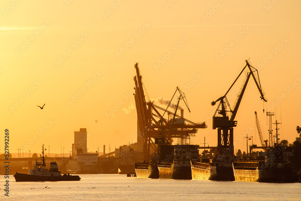 Cargo vessels and boats at Gdynia COntainer Terminal during the Sunset