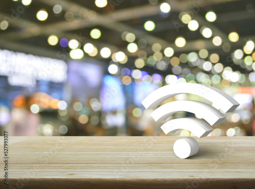 Wi-fi 3d icon on wooden table over blur light and shadow of shopping mall, Technology internet communication concept