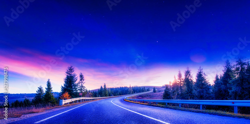 High-quality asphalt road in the mountains before dawn.