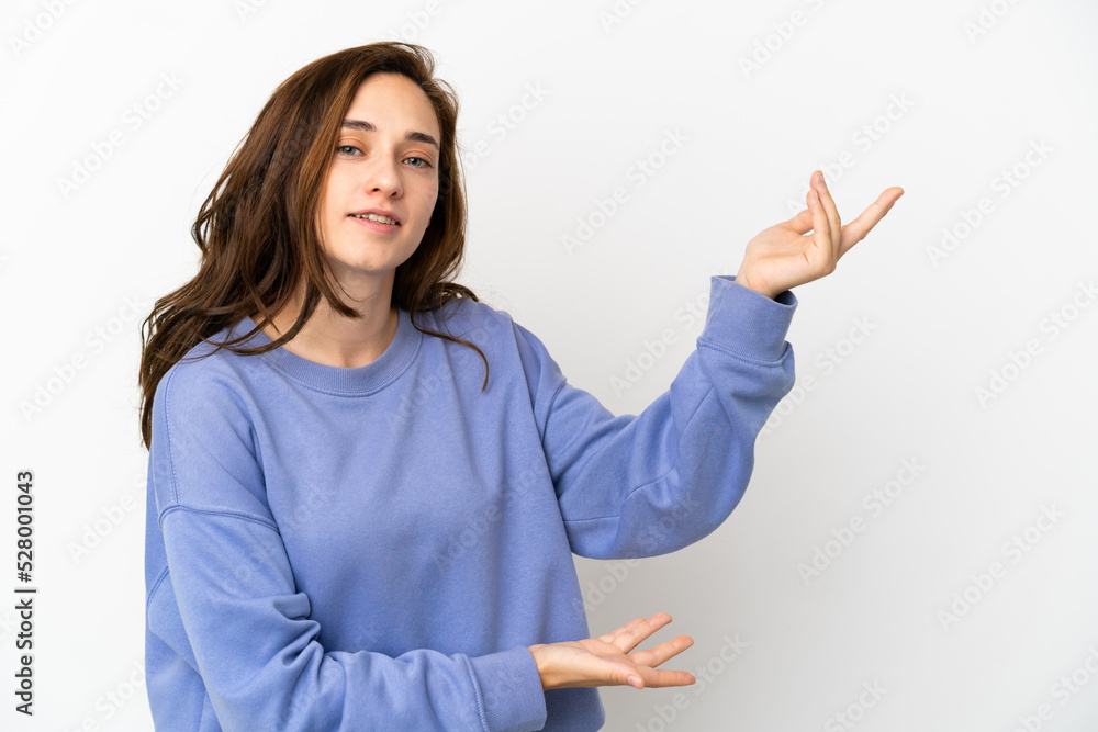 Young caucasian woman isolated on white background extending hands to the side for inviting to come Young caucasian woman isolated on white background extending hands to the side for inviting to come