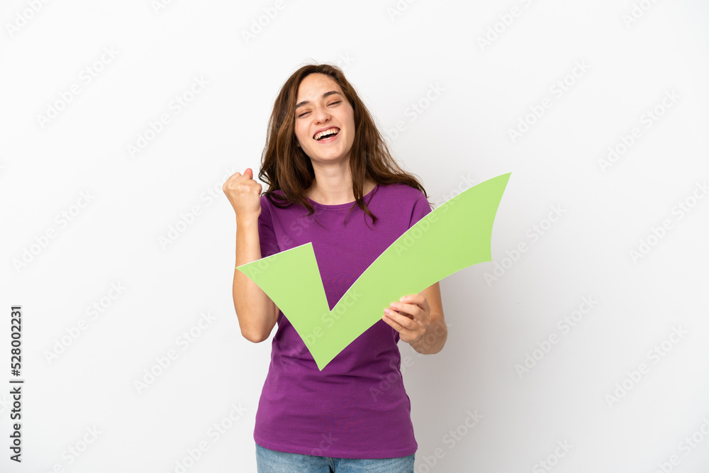 Young caucasian woman isolated on white background holding a check icon and celebrating a victory Young caucasian woman isolated on white background holding a check icon and celebrating a victory