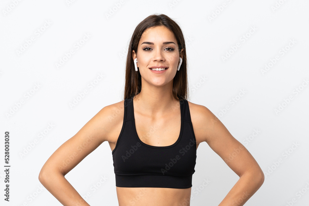 Young sport woman isolated on white background posing with arms at hip and smiling Young sport woman isolated on white background posing with arms at hip and smiling