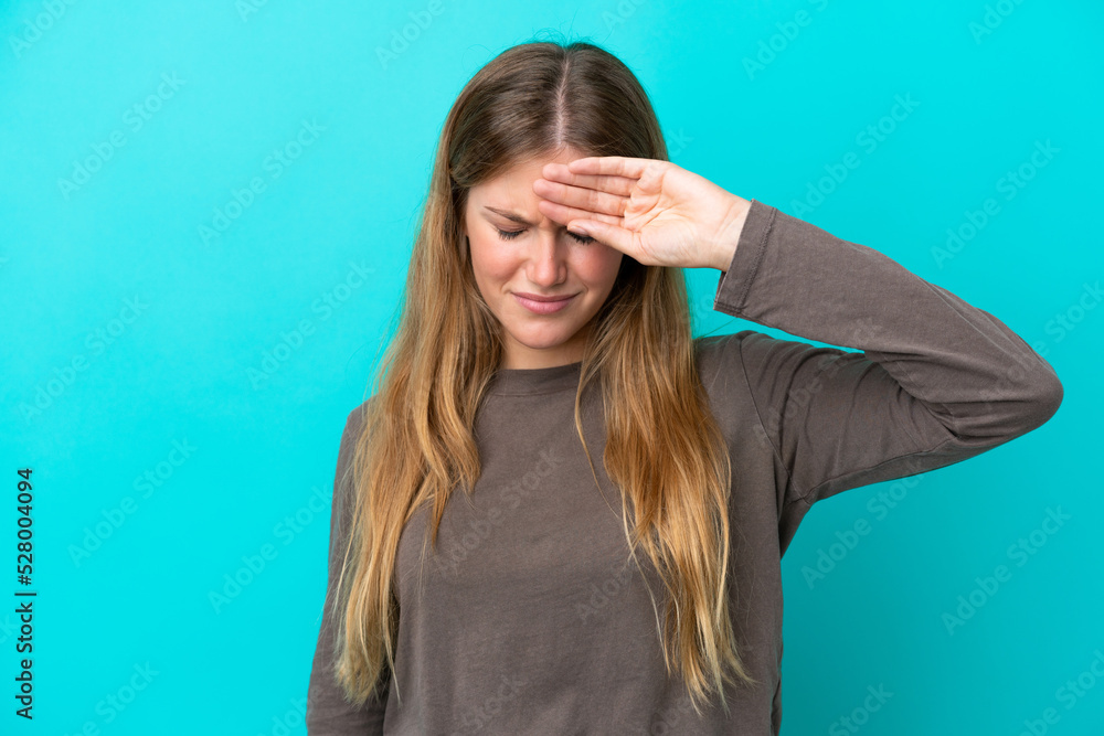 Young blonde woman isolated on blue background with tired and sick expression Young blonde woman isolated on blue background with tired and sick expression