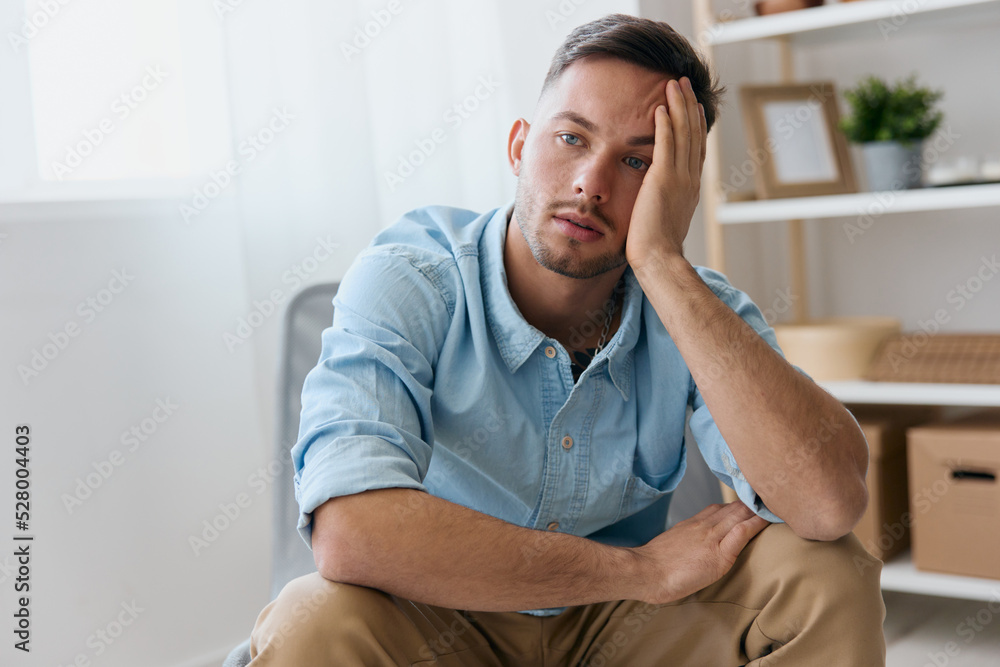 Sad frustrated young man reclines on hand looks aside think about difficult life decision bad news health problem. Upset guy have depression need professional psychology help. Copy space for ad Sad frustrated young man reclines on hand looks aside think about difficult life decision bad news health problem. Upset guy have depression need professional psychology help. Copy space for ad