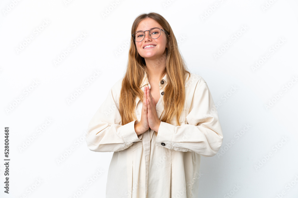Young blonde woman isolated on white background keeps palm together. Person asks for something Young blonde woman isolated on white background keeps palm together. Person asks for something