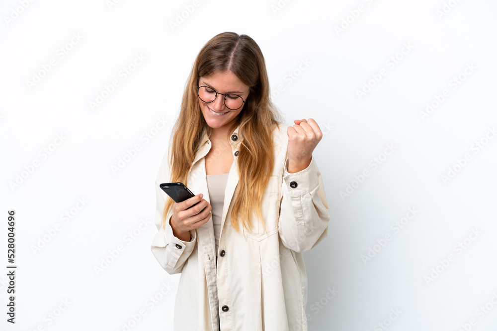 Young blonde woman isolated on white background with phone in victory position Young blonde woman isolated on white background with phone in victory position