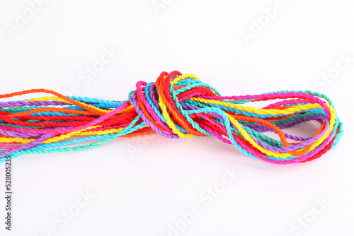 Colorful paper rope with knot isolated on white .