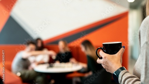 person with coffee cup in room