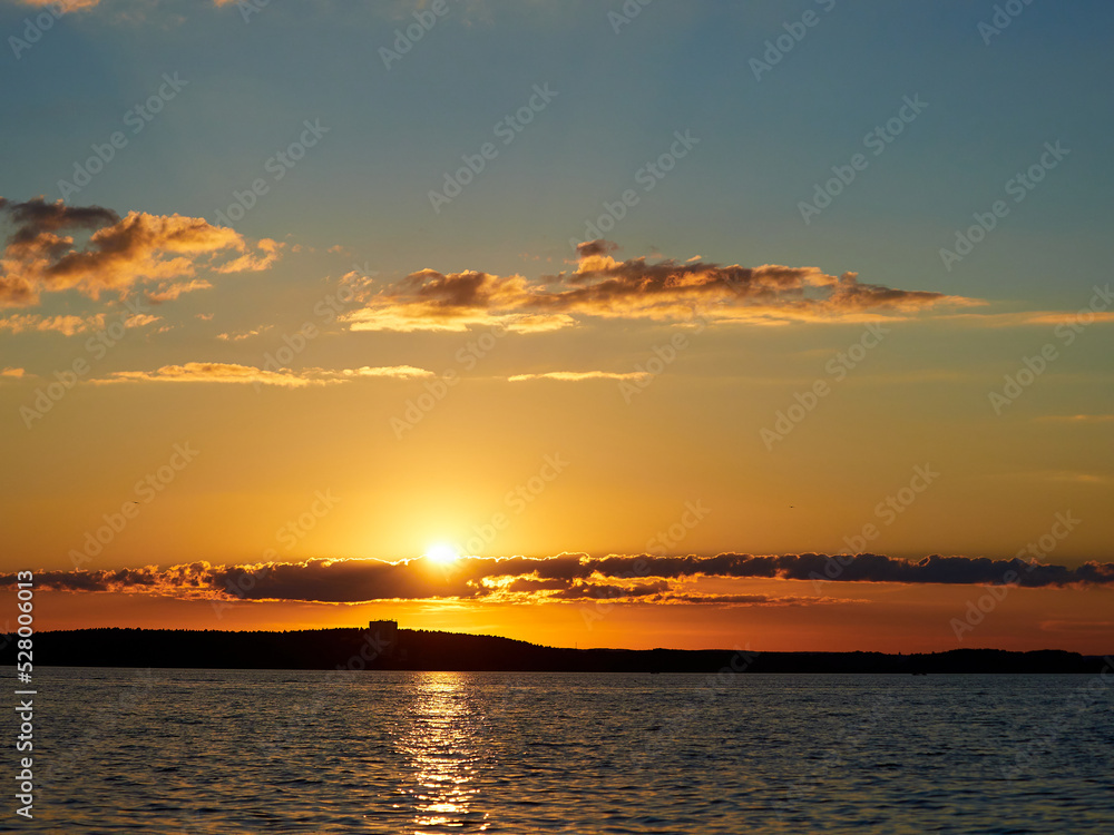 Beautiful sunset. Sunset over the water. The sun sets over a large lake.