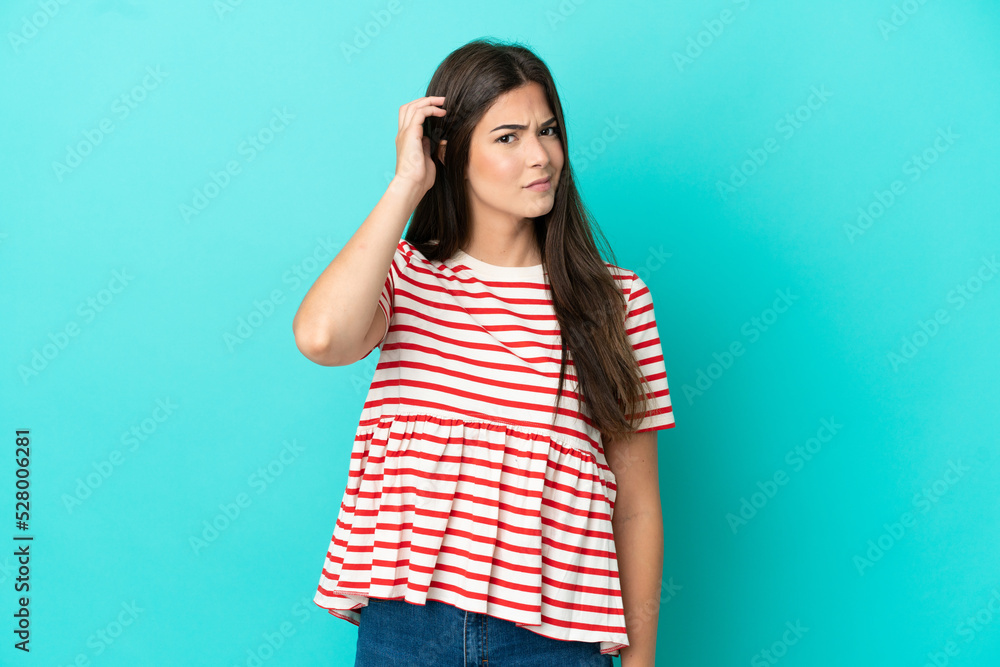 Young Brazilian woman isolated on blue background having doubts Young Brazilian woman isolated on blue background having doubts