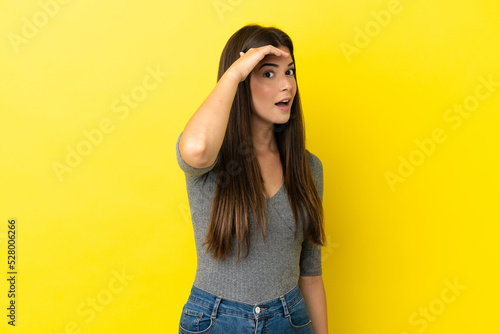 Tablou canvas Young Brazilian woman isolated on yellow background doing surprise gesture while