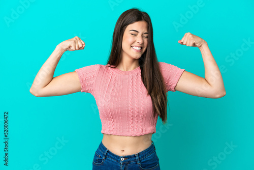 Fotografia Young Brazilian woman isolated on blue background doing strong gesture