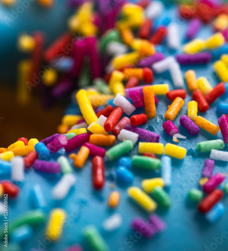 Macro shot of colorful sprinkles on a donut. Background banner.