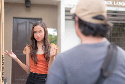 A female teenager in a rage looks at the camera with furrowed brows.