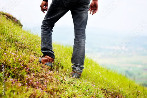 person walking on the grass while trekking
