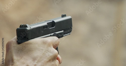 Pistol shooting bullets in slow motion footage. Hand guns in firing range