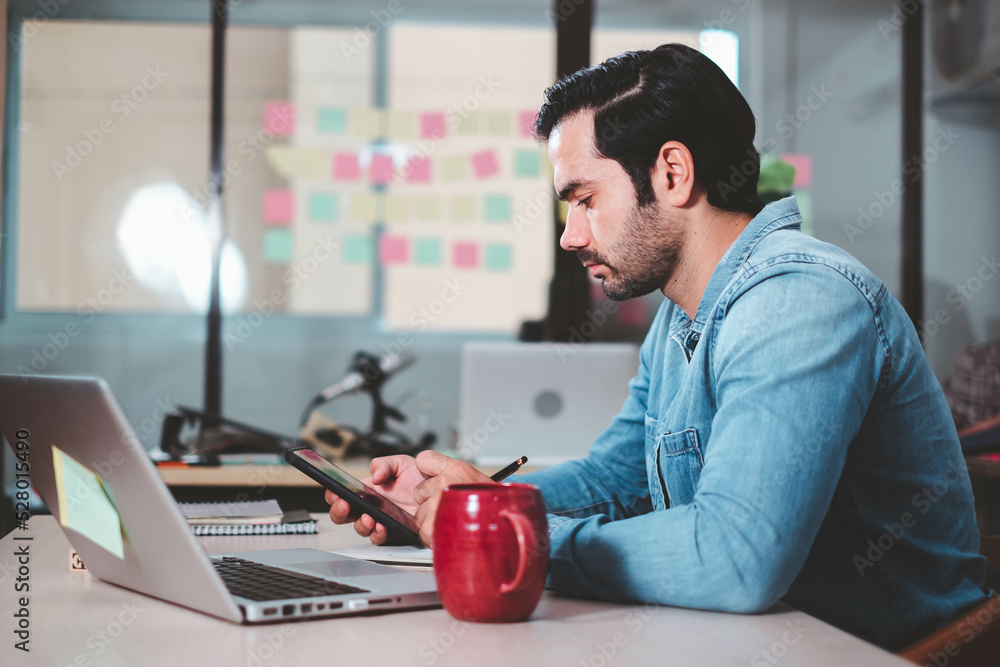 custom made wallpaper toronto digitalConfident Businessman executive commuter is looking at hand held digital tablet screen. Confident professional making successful plan while working on laptop at office.