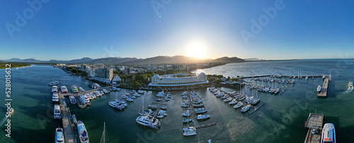 Aerial panorama of Cairns city and boat harbour at sunset