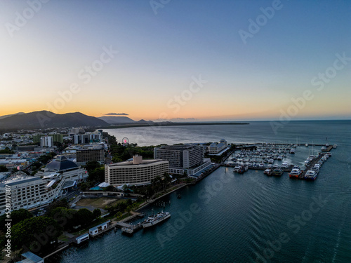 Aerial sunset photo of booat harbour and cityscape with orange sky