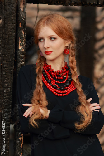 Beautiful Woman in traditional ukrainian style. Ukrainian National Costume. Gorgeous young Woman with red lips. Portrait attractive Girl with a red necklace. Slavonic Girl with long blond hair.