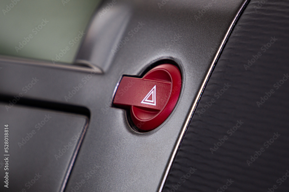 Hazard lights button. Car interior with red emergency stop button