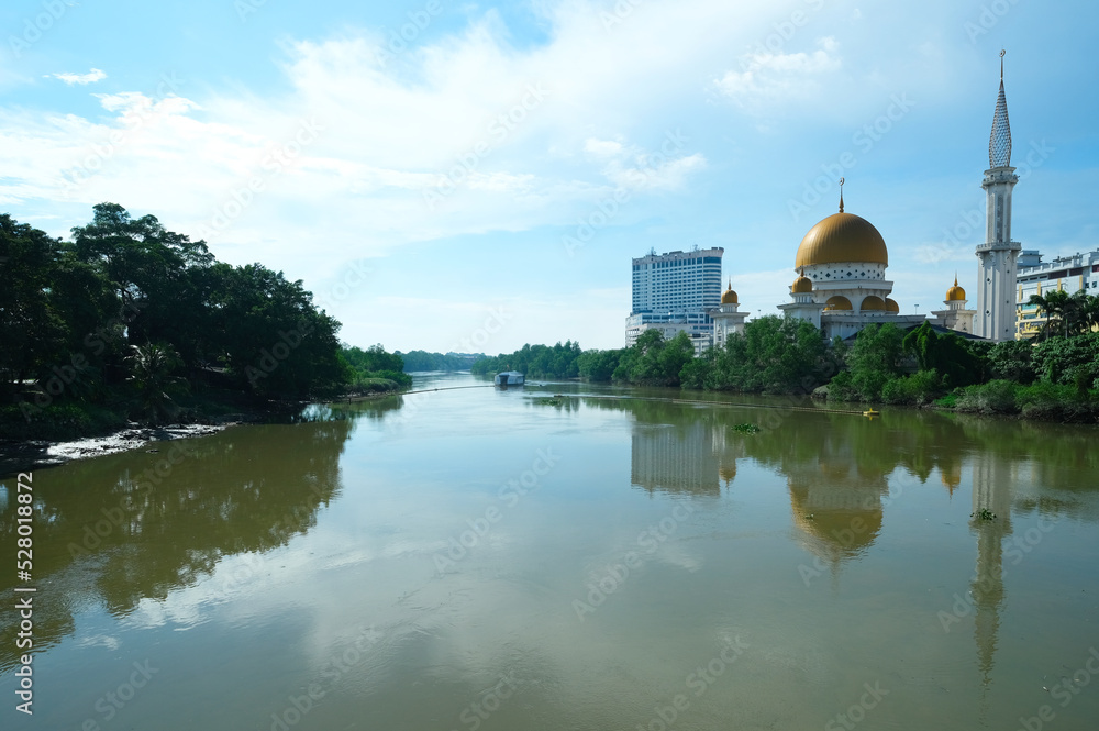 Selective focus picture with noise effect Mosque with golden dome at Klang Riverside during daytime