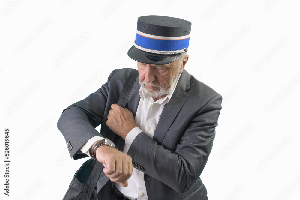 The train conductor looks at his wristwatch while waiting for the train to depart. Isolated. On a white background. The train conductor looks at his wristwatch while waiting for the train to depart. Isolated. On a white background.