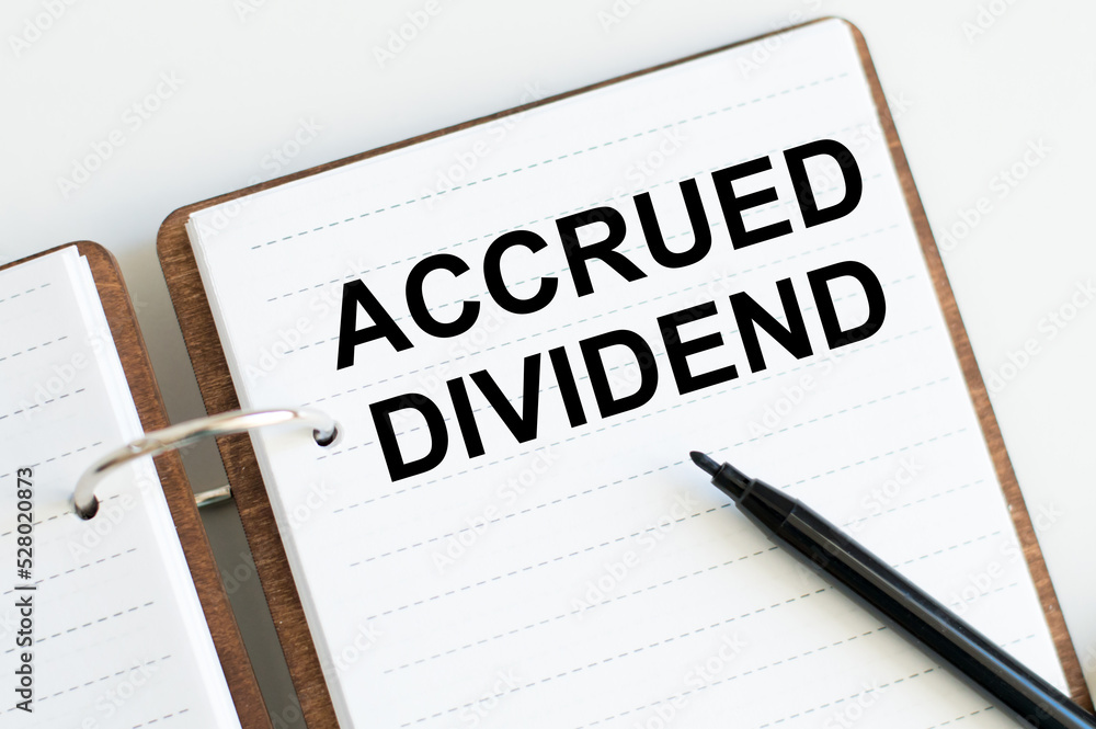 business concept. ACCRUED DIVIDEND text on notepad sheet on table business concept. ACCRUED DIVIDEND text on notepad sheet on table