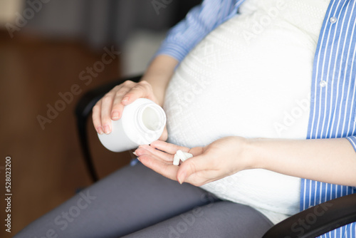 Photos medicines for pregnancy, a pregnant woman takes pills, health and medicine, vita