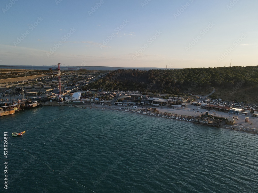 Aerial view of Zrce Beach Festival in Novalja, island Pag, archipelago of Croatia. People partying on a hot summer day on Zrce beach. Zrce beach is the most popular party destination on Adriatic sea.