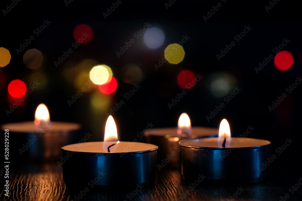 Candle light and bokeh background in the darkness with space for text ...