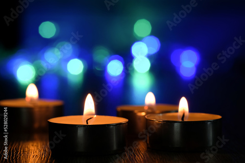 Candle light and bokeh background in the darkness with space for text or image.