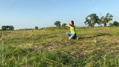 Wallpaper Mural Mother cuddling children while having leisure at nature sunset. Family with two children spending time together outdoors. Little boy and girl embracing woman at meadow. Happiness in simply living Torontodigital.ca
