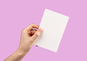 Hand holding card mockup on pink background. Template for congratulation, love confession, romantic letter. Valentines day greeting.