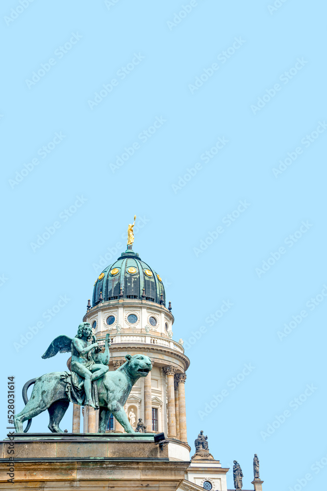 Cover page with statue of panther with genius of music, angel with wings and harp, stringed musical instrument at Concert Hall at French Church in Berlin, Germany with blue sky background copy space.