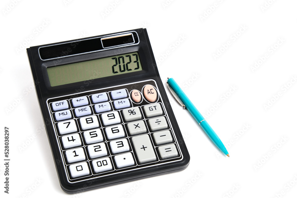 Calculator turned off and a ballpoint pen on white background. Calculator turned off and a ballpoint pen on white background.